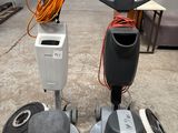 two machines that are sitting on the floor in the garage