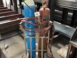 a large blue tank sitting on top of a metal cart
