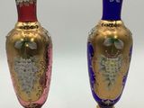 pair of vases with floral designs on gold base and blue base