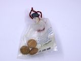 a bag of coins sitting on top of a white table