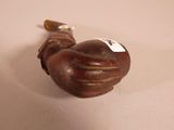 a small wooden pipe with a white tag on it