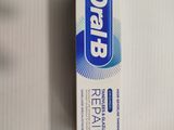 toothpaste in a box on a table with a tooth brush