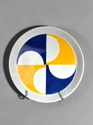 yellow, blue, and white plate with a circular design on it