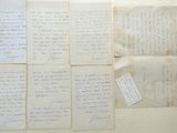 several pieces of old paper with handwriting on them sitting on a table