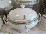 a lot of plates and bowls on the table