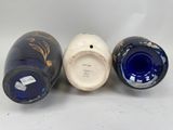 three blue and white vases sitting next to each other on a table