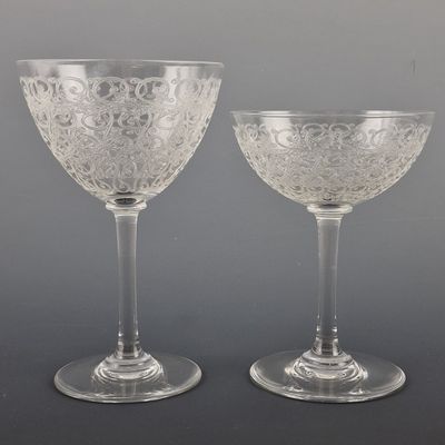 pair of etched glass goblets with raised rims