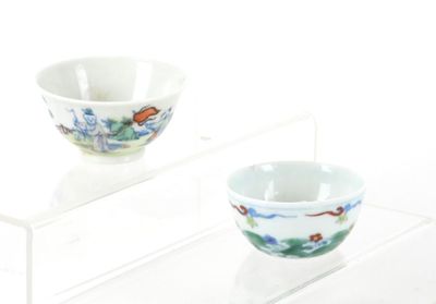 two bowls sitting on a clear shelf next to each other