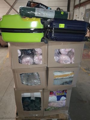a cart with a green suitcase on top of it in a warehouse