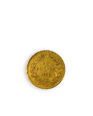 gros plan d'une pièce d'or sur une surface blanche