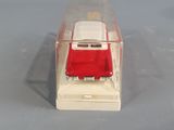 a small toy car in a clear box on a table