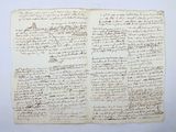 an old manuscript with writing on it sitting on top of a table