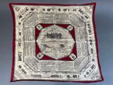 a red and white pillow with a picture of a castle on it