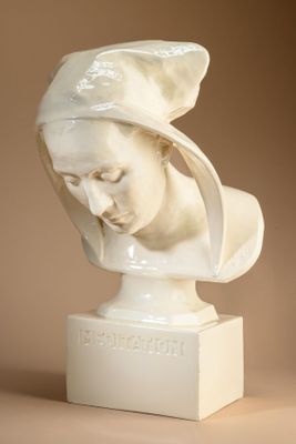 statue of a woman with a hat on her head on a pedestal