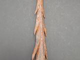 an old rusty tree branch on a gray surface