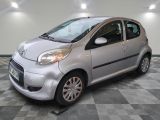 a picture of a small silver car on a checkered floor