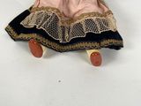 an image of a doll is sitting on a white surface