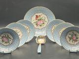 five blue and white plates and a spoon on a table