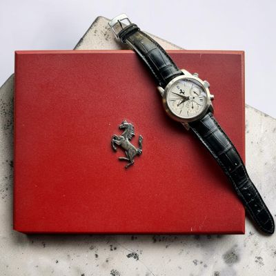 une montre posée sur une boîte rouge, sur une table
