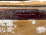 a close up of a piece of wood with a sign on it