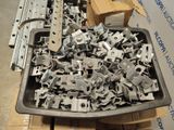 a tray full of metal parts sitting on a pallet