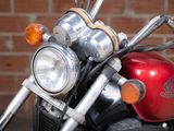 a red motorcycle parked in front of a brick wall
