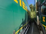 two trucks that are side by side on the road