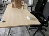 a desk with chairs and boxes on it in an office