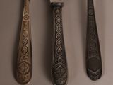 three spoons and a knife on a table