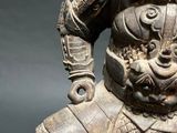 an image of a statue of a man sitting on top of a table