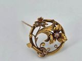 an image of a close up of a brooch with flowers on it