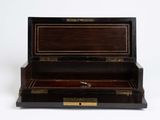 a wooden box with a key in it on a white surface