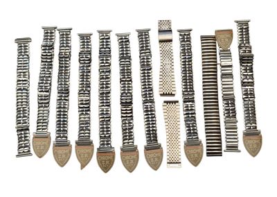 several different types of watch bands are lined up on a white surface