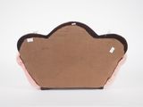 a brown and pink pillow that is on a white surface