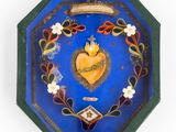 painting of a sacred heart on a blue background in a decorative frame