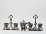 three pieces of silver and blue glass on a white surface