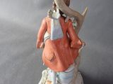 a figurine of a man with a bird on his head