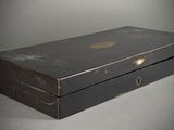 a black box that has a gold button on it