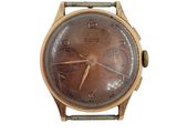 une vieille montre-bracelet avec un cadran marron sur fond blanc