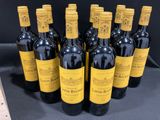 six bottles of wine are lined up in a row on a table