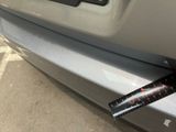 a sticker on the bumper of a car that has a sticker attached to it