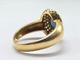 an image of a gold ring with a blue stone in the center
