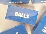 four blue boxes with the words balls on them are sitting on a table