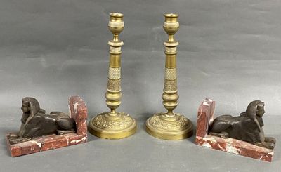 three antique brass candlesticks with sphinx statues on marble bases