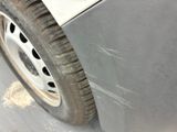 a close up view of a car ' s front bumper and tire