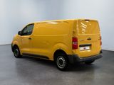 the yellow van is parked in the empty room of the building