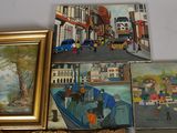 many paintings on the wall of a room