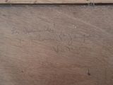 a piece of wood that has writing on it