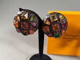 an image of a pair of earrings sitting on top of a table
