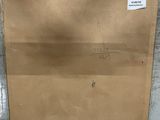 a brown paper bag sitting on the floor with a tag on it